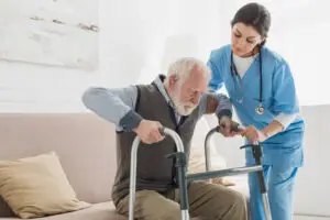 Elderly man receiving in-home physical therapy to improve strength and balance.