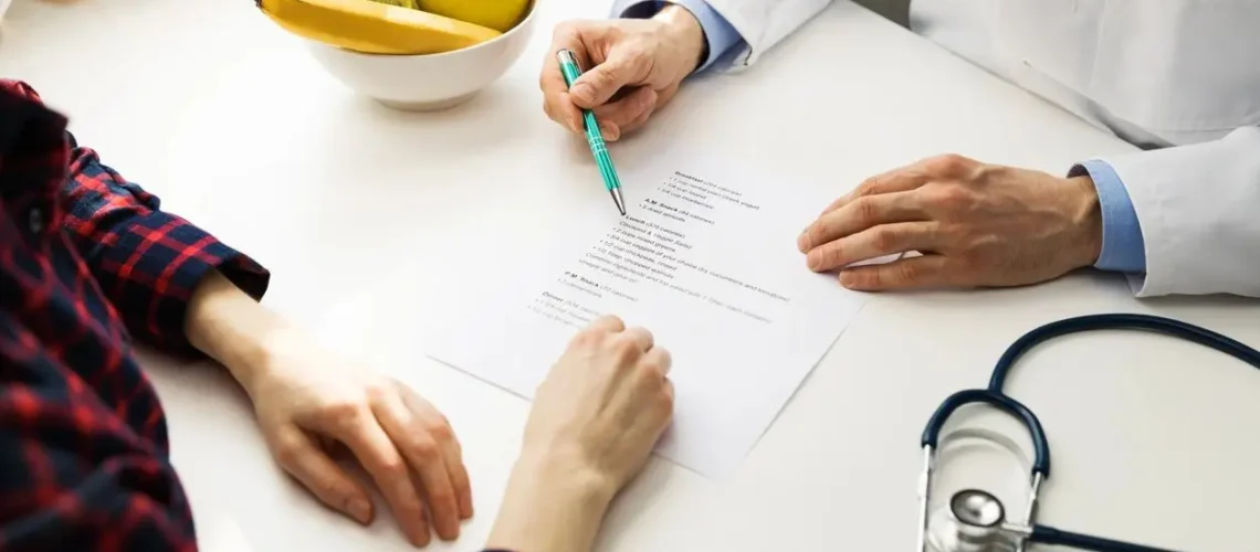 "A caring home health nurse reviewing insurance paperwork with an elderly patient and family member at home"